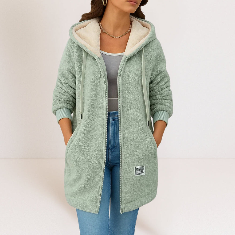 Hellgrüne Longline-Kapuzenjacke aus kuscheligem Sherpa-Fleece mit Reißverschluss und kontrastfarbenem Innenfutter.