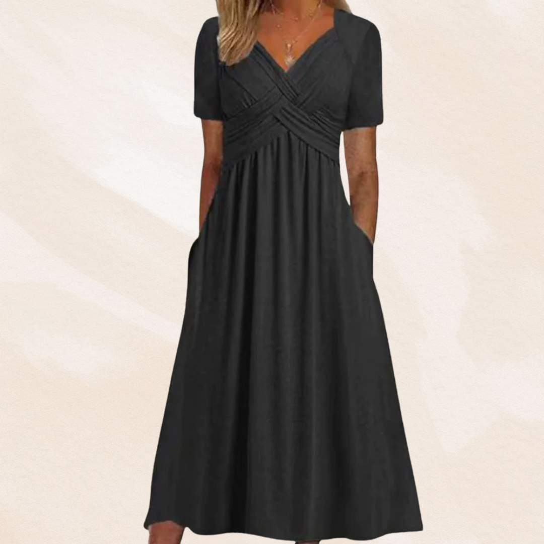 Alina Damen Midikleid in Schwarz mit V-Ausschnitt, Wickel-Oberteil, kurzen Ärmeln und praktischen Seitentaschen.