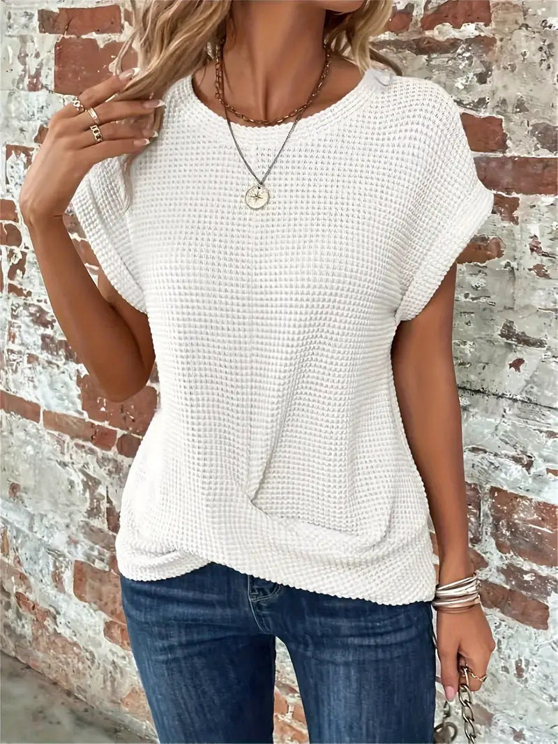 Weißes Damen-Shirt in Waffelstrick mit Rundhals, gerollten Ärmeln und modischem Front-Twist am Saum.
