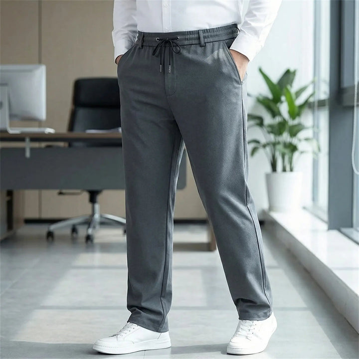 Dunkelgraue Herren-Stoffhose mit geradem Schnitt, elastischem Komfortbund, Kordelzug und praktischen Reißverschlusstaschen.