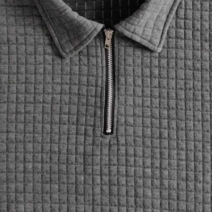 Dunkelgraues Herren-Poloshirt mit Waffelstruktur, Reißverschluss am Kragen und modernem, strukturiertem Stoffdesign.