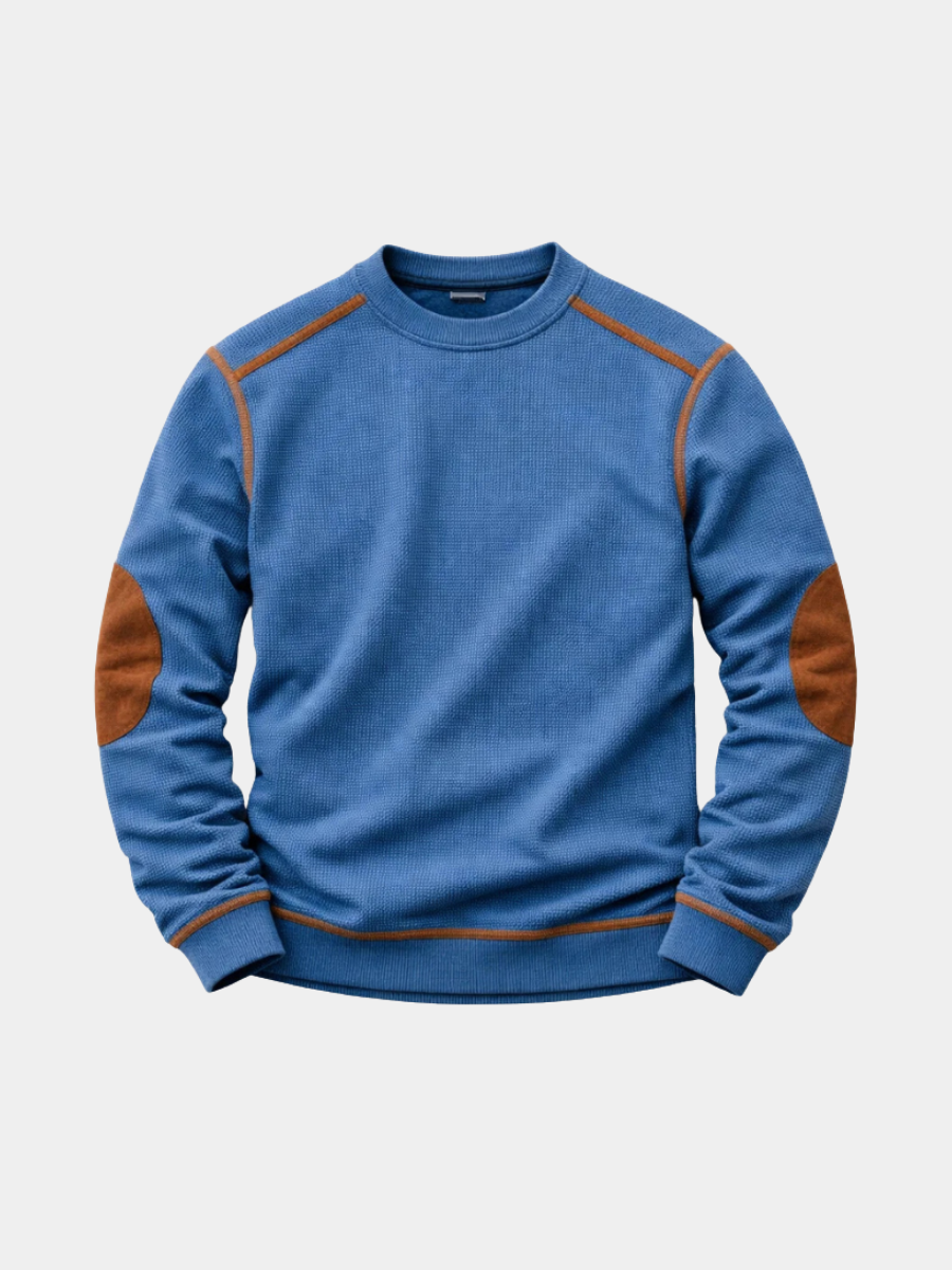 Blauer Herren-Strickpullover mit Waffelstruktur, Rundhalsausschnitt und braunen Ellbogen-Patches.