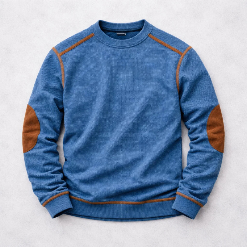 Blauer Herren-Strickpullover mit Waffelstruktur, Rundhalsausschnitt und braunen Ellbogen-Patches.