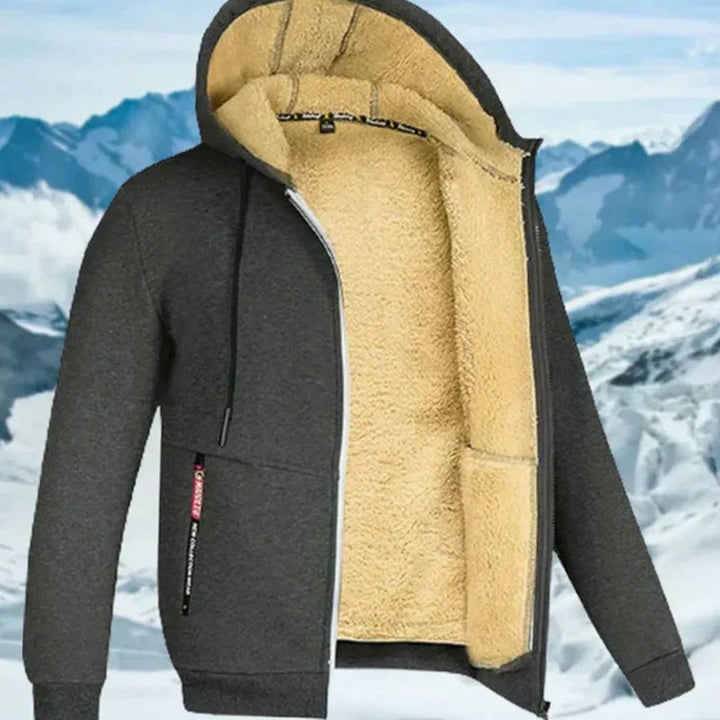 Dunkelgraue Fabio Kapuzenjacke mit kuscheligem beigem Fleecefutter, Reißverschluss und praktischen Taschen für den Winter.
