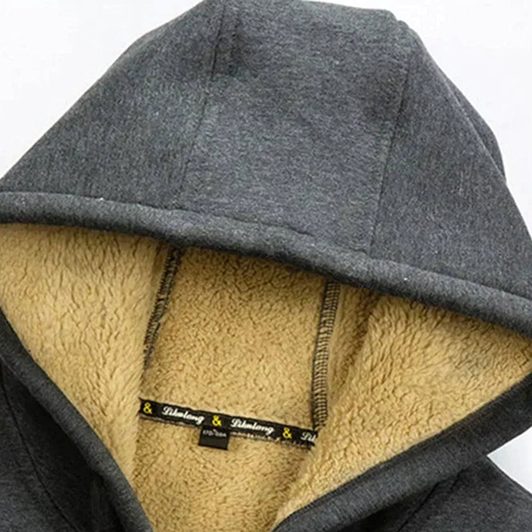 Dunkelgraue Fabio Kapuzenjacke mit kuscheligem, beigem Fleecefutter für maximale Wärme an kalten Tagen.