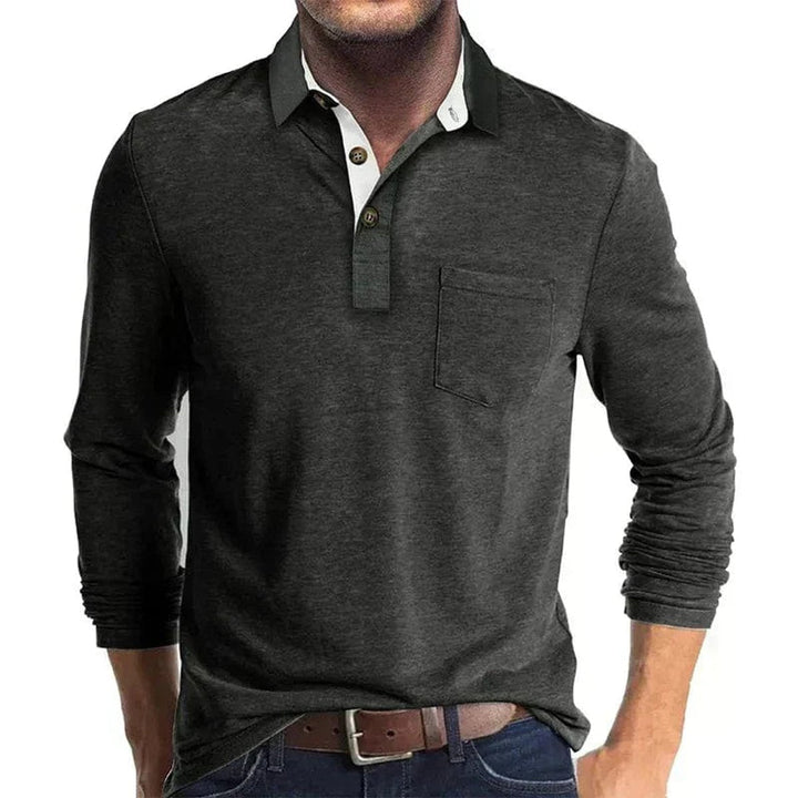 Dunkelgraues Langarm-Poloshirt mit Brusttasche, kontrastierendem Kragen und Knopfleiste für einen eleganten Look.