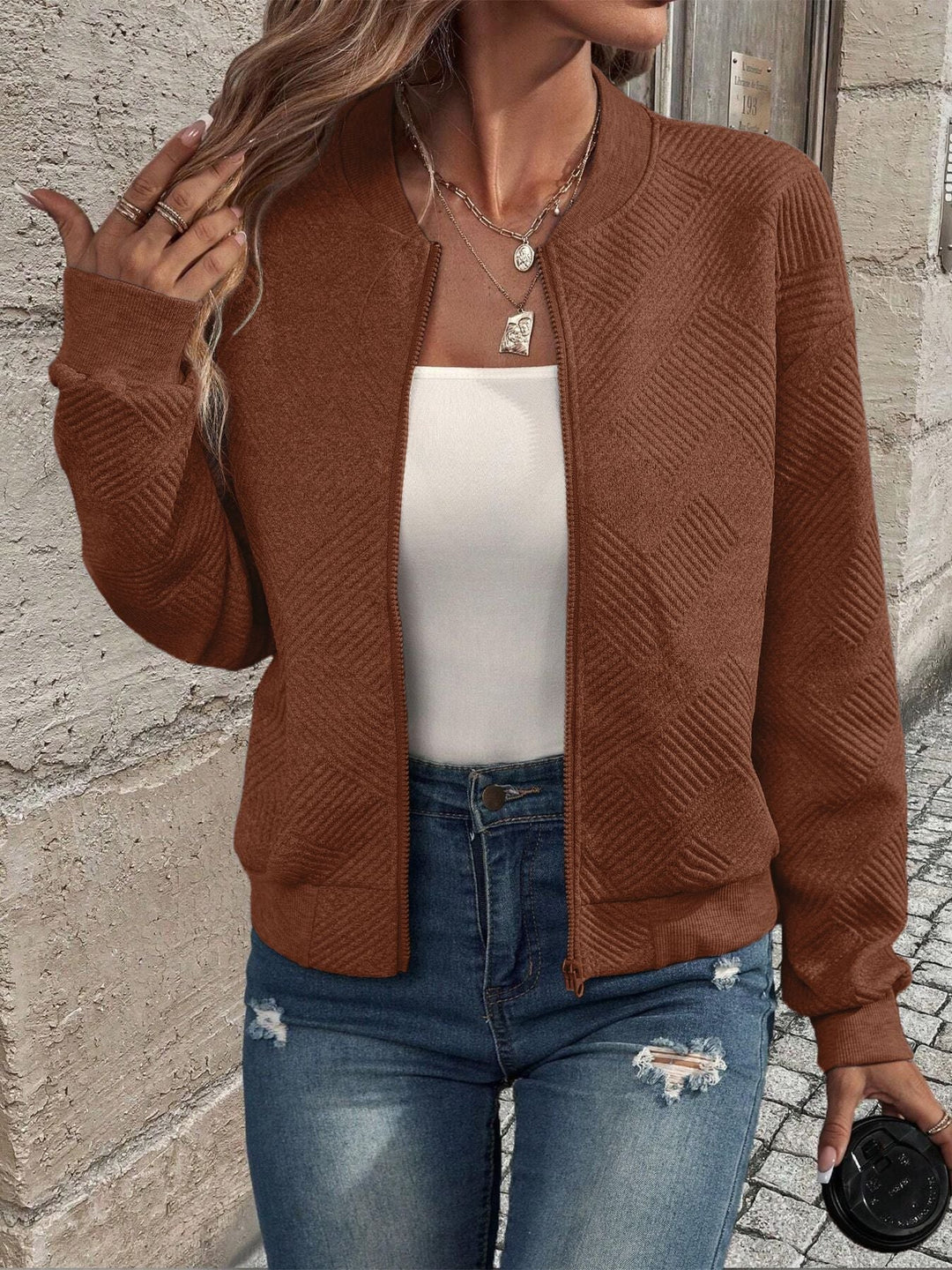 Braune Damen-Strickjacke mit Reißverschluss, strukturiertem Muster, Stehkragen und gerippten Bündchen.