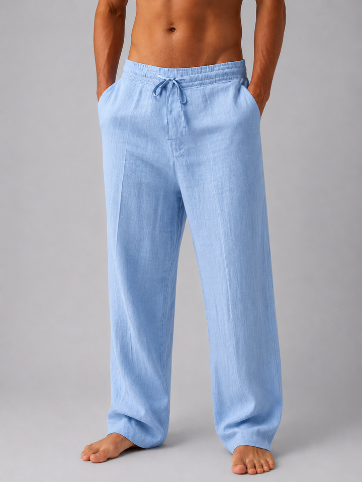 Hellblaue Herren-Leinenhose mit elastischem Bund, Kordelzug und entspannter Passform vor grauem Hintergrund.