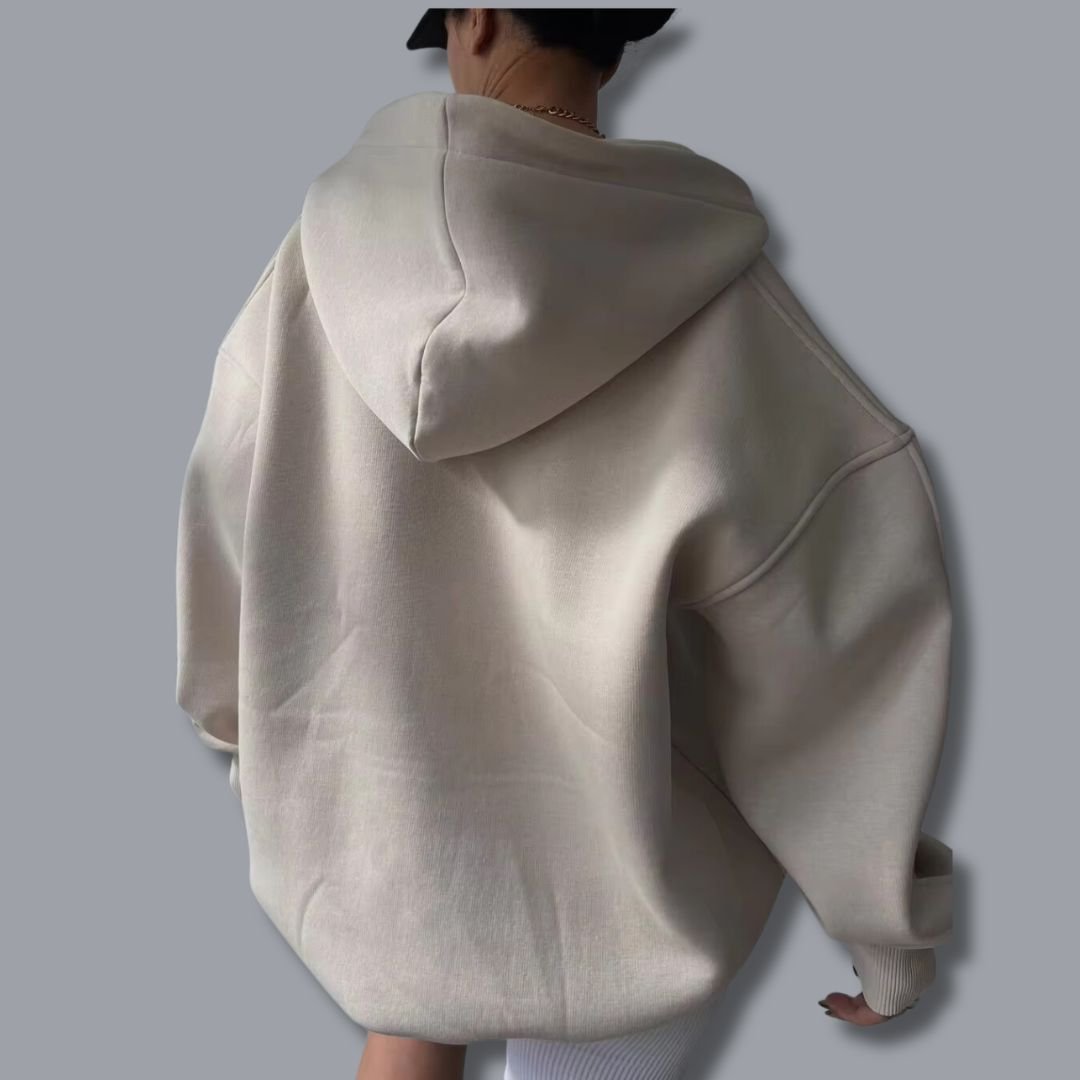 Beiger Oversized-Hoodie mit Kapuze, überschnittenen Schultern und gerippten Bündchen in lässiger Passform.