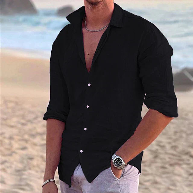 Schwarzes Herren-Leinenhemd mit Langarm, klassischem Kragen und Knopfleiste am Strand.