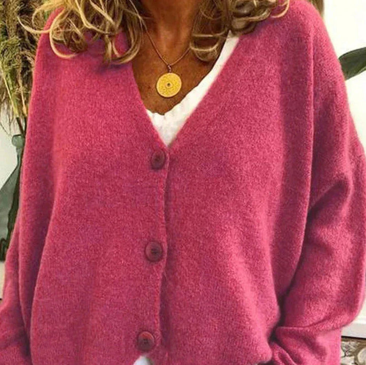 Dunkelrosa Strickjacke Noemi mit V-Ausschnitt, Knopfleiste und weichem Material für einen femininen Look.