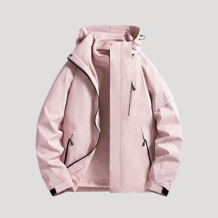 Hellrosa wasserdichte Damen-Outdoorjacke mit Kapuze, Reißverschlusstaschen und sportlichem Design.