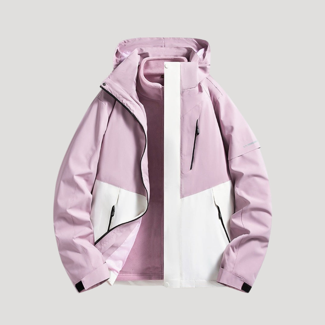 Hellrosa und weiße Damen Outdoorjacke mit Kapuze, Reißverschlusstaschen und wasserabweisendem Material.