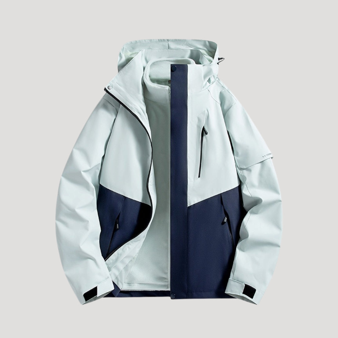 Marei Damen Outdoorjacke in Hellblau und Dunkelblau mit Kapuze, Reißverschlusstaschen und wasserabweisendem Material.