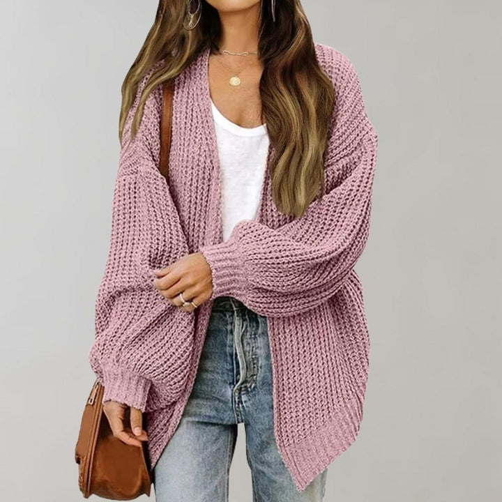 Rosa Oversized-Strickjacke aus grobem Strick mit offener Vorderseite und weiten Ärmeln für einen lässigen Look.