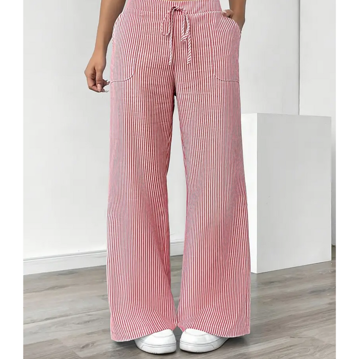 Weite Leinenhose mit rot-weißem Streifenmuster, Kordelzug am Bund und aufgesetzten Seitentaschen.