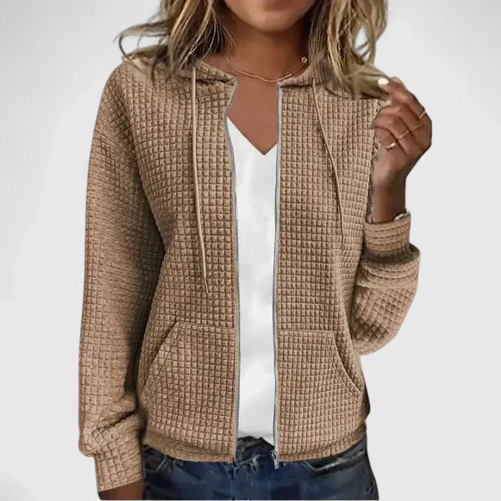 Beige Damen-Steppjacke mit Waffel-Optik, Kapuze, Kordelzug und durchgehendem Reißverschluss.