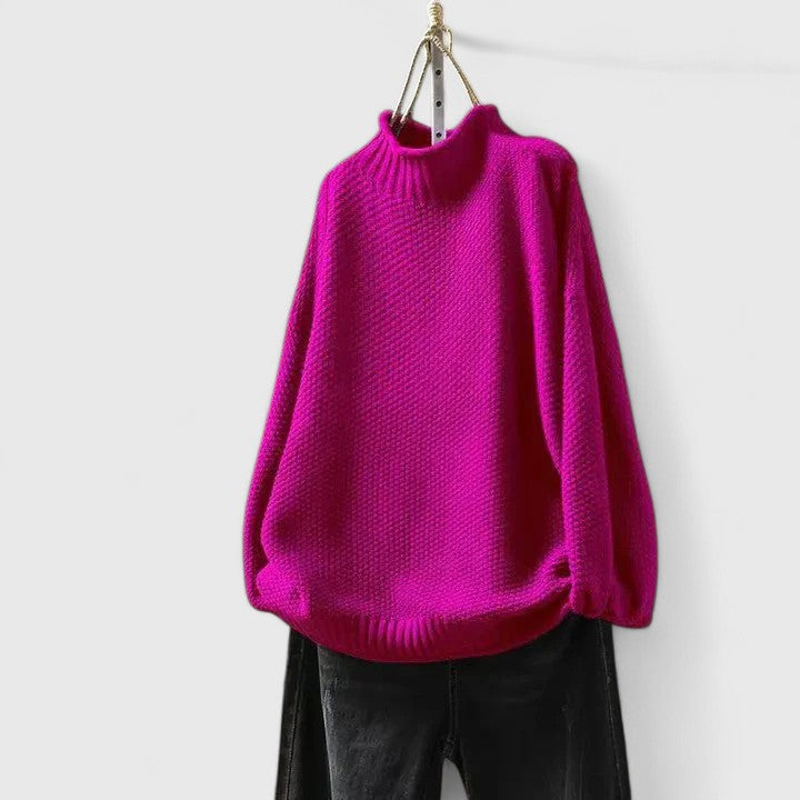 Pinker Damen-Strickpullover mit Stehkragen, strukturiertem Strickmuster und überschnittenen Schultern.