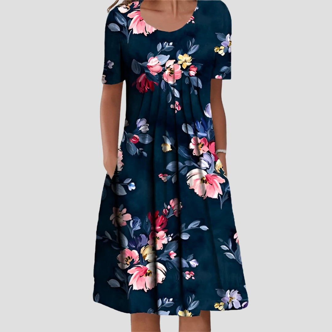 Dunkelblaues Midikleid mit Blumenmuster, Rundhalsausschnitt, kurzen Ärmeln, A-Linien-Schnitt und praktischen Seitentaschen.