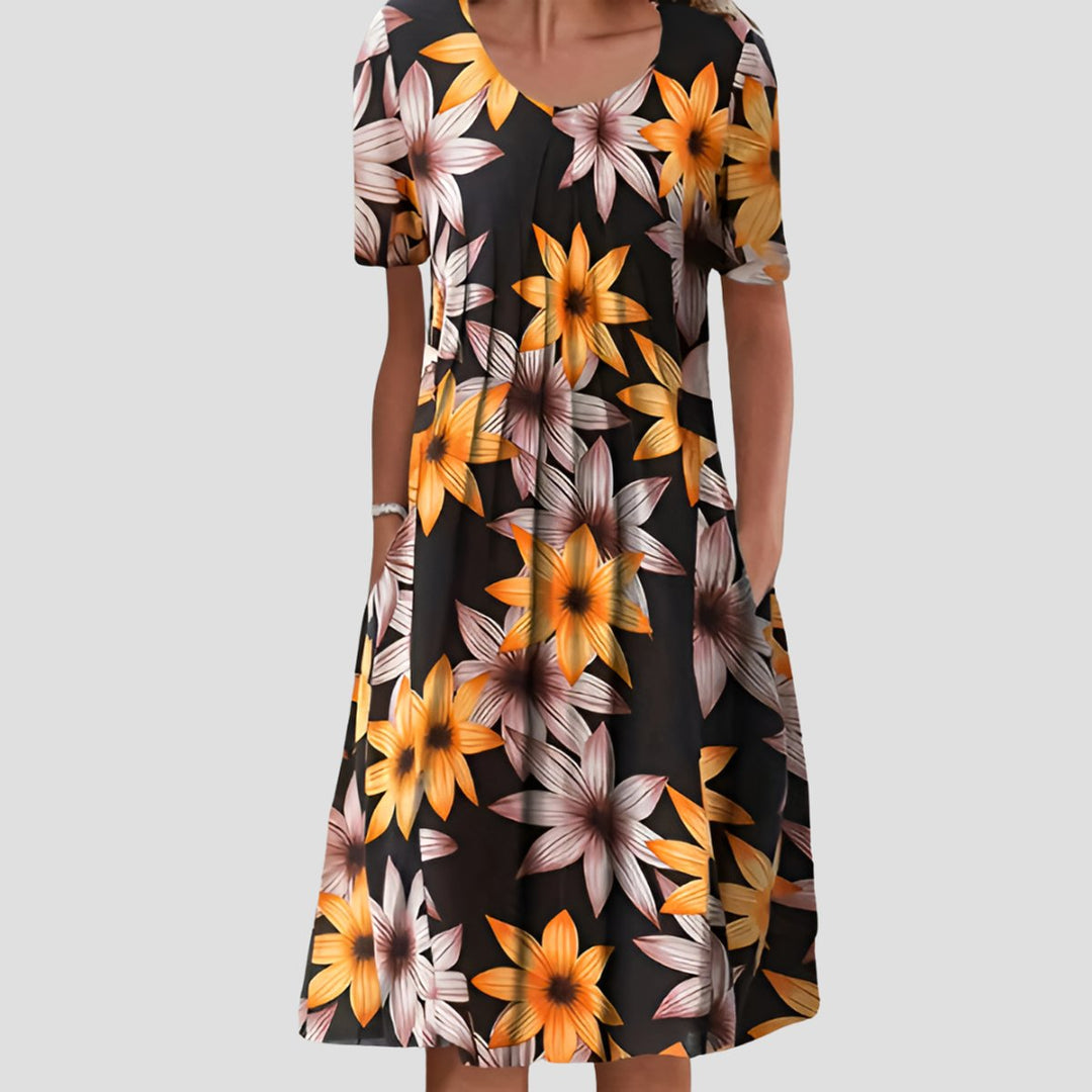 Schwarzes Midikleid in A-Linie mit gelbem Blumenmuster, Rundhalsausschnitt, kurzen Ärmeln und praktischen Seitentaschen.