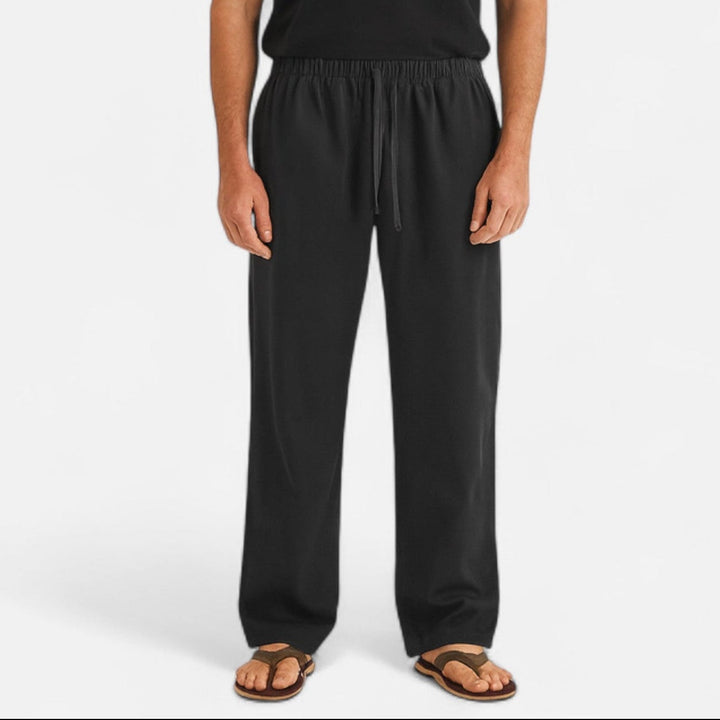 Schwarze Herren-Relaxhose mit weitem Schnitt, elastischem Bund und Kordelzug für maximalen Tragekomfort.