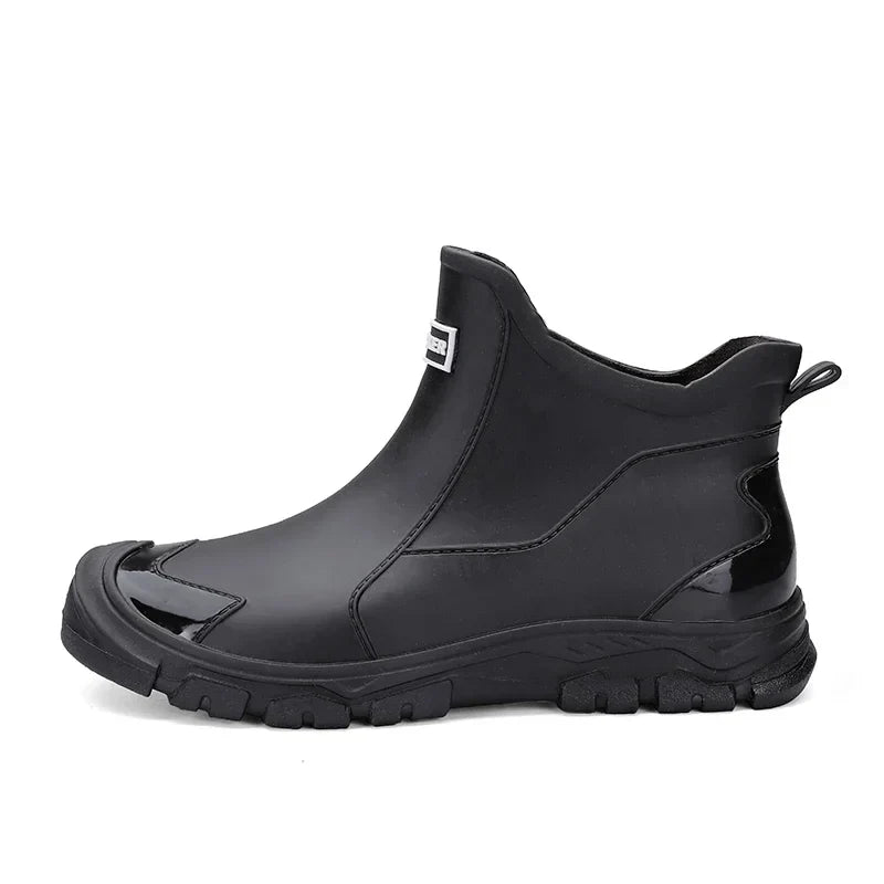 Schwarze, wasserdichte Damen-Regenstiefeletten im Slip-on-Design mit robuster Profilsohle und verstärkter Zehenkappe.
