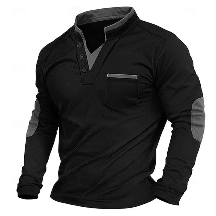 Schwarzes Langarm-Shirt mit Stehkragen, Knopfleiste, Brusttasche und grauen Kontrastakzenten an Kragen und Ellbogen.