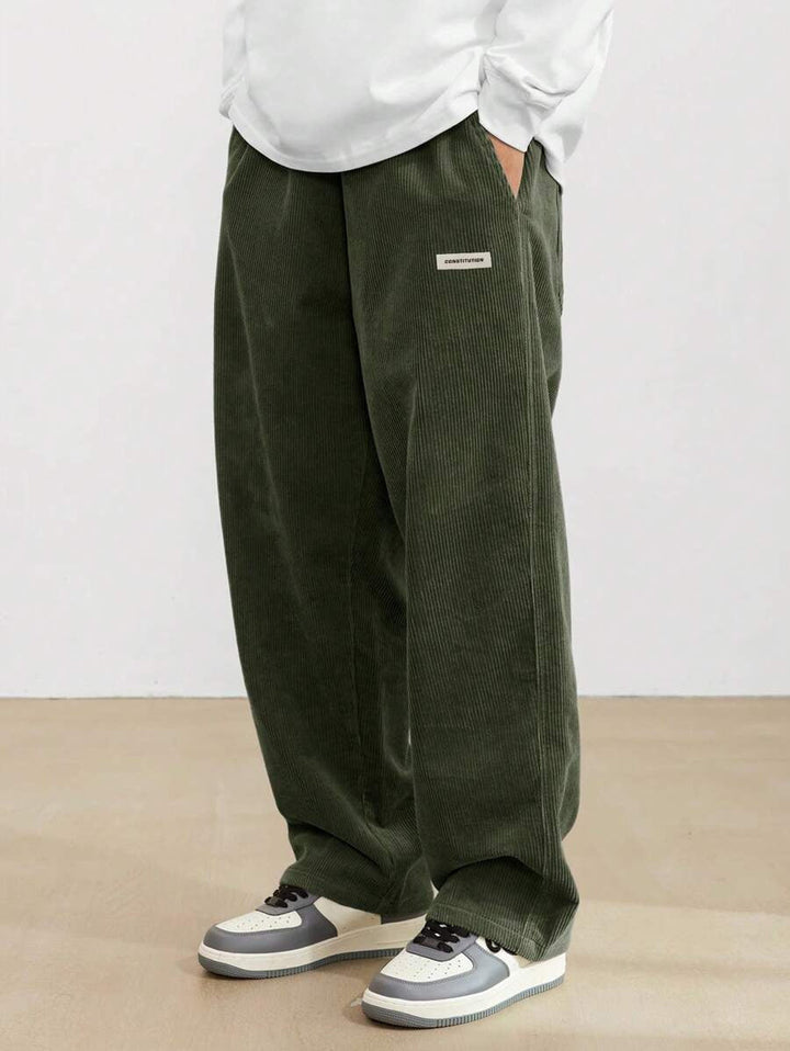Dunkelgrüne Herren-Cordhose im weiten Schnitt mit elastischem Bund und praktischen Seitentaschen für einen lässigen Look.
