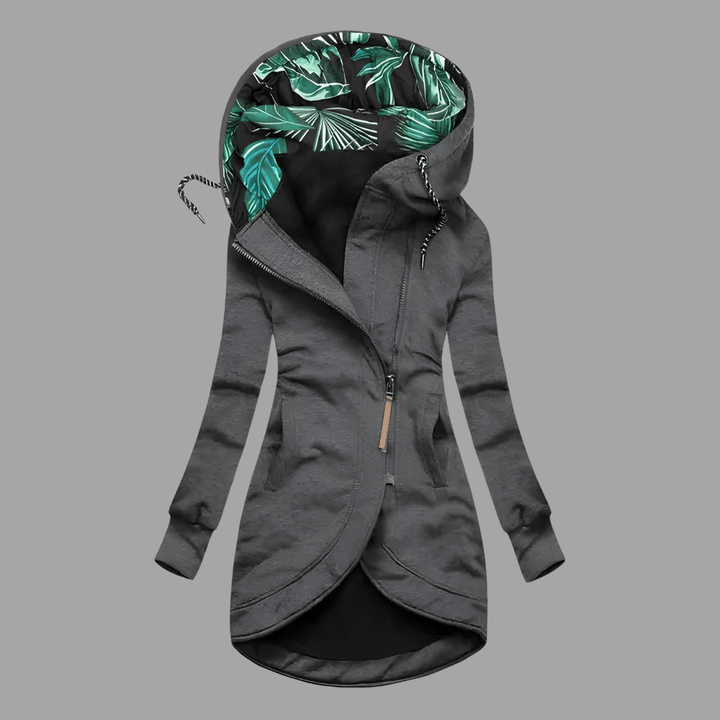 Dunkelgraue Damen-Kapuzenjacke mit asymmetrischem Reißverschluss und grünem Blattmuster-Innenfutter an der Kapuze.